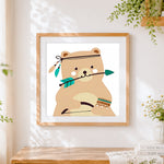 Finished cute tribal bear with arrow cross stitch artwork displayed