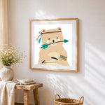 Cute tribal bear with arrow cross stitch artwork displayed on wall as home decor