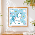 Finished cute unicorn with crown and hearts cross stitch artwork displayed