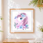 Finished cute unicorn with pink hair and flowers cross stitch artwork displayed