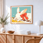 Cute white bunny sleeping on a piano cross stitch artwork displayed on wall as home decor