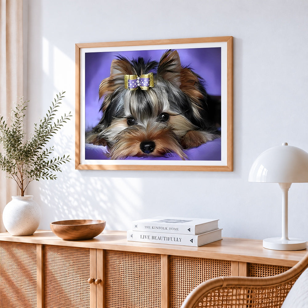 Cute yorkshire terrier with bow cross stitch artwork displayed on wall as home decor