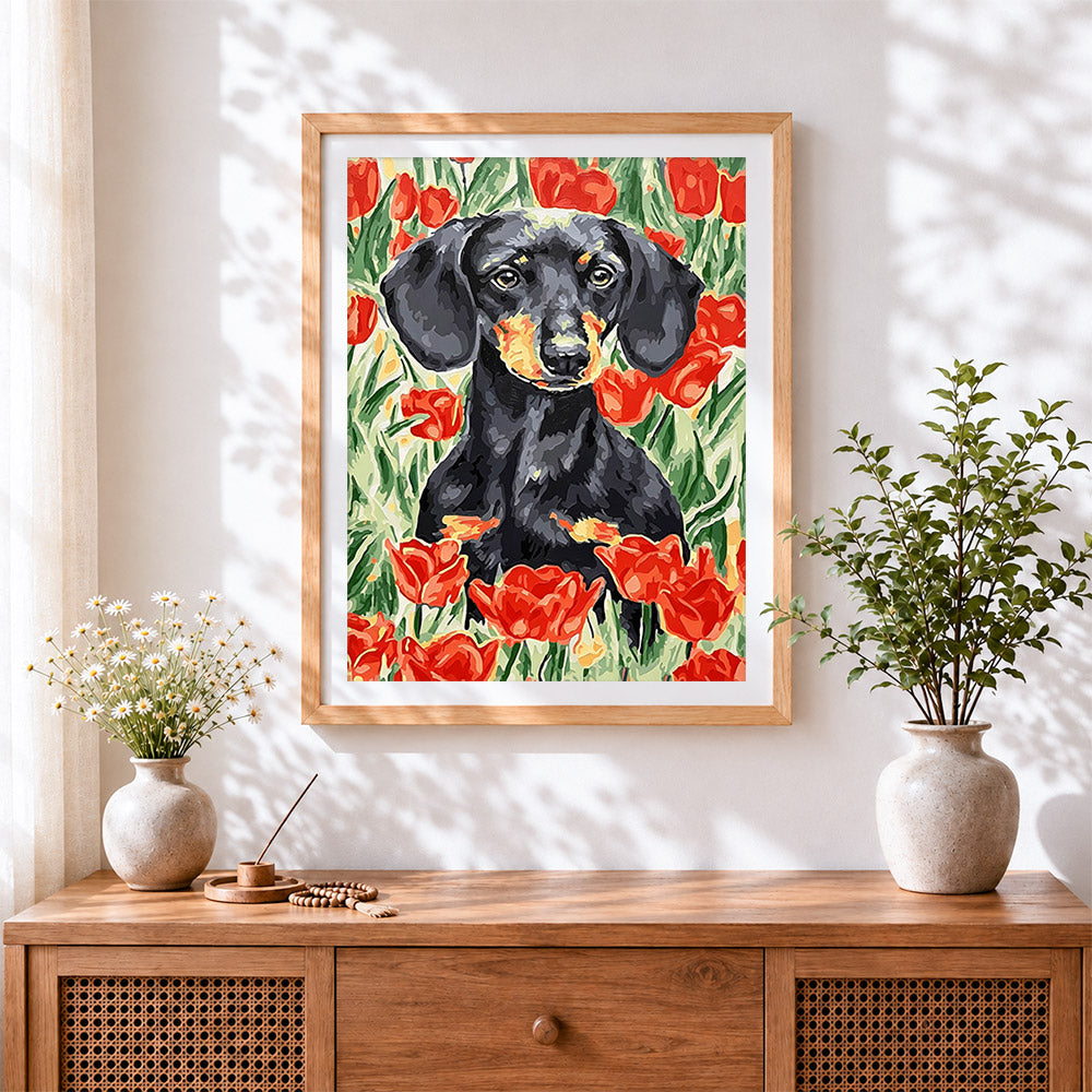 Finished dachshund among red tulips cross stitch artwork displayed
