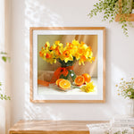 Finished daffodils and oranges still life cross stitch artwork displayed