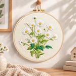 Daisies on beige background embroidery hoop wall art displayed as warm and cosy handmade home decor