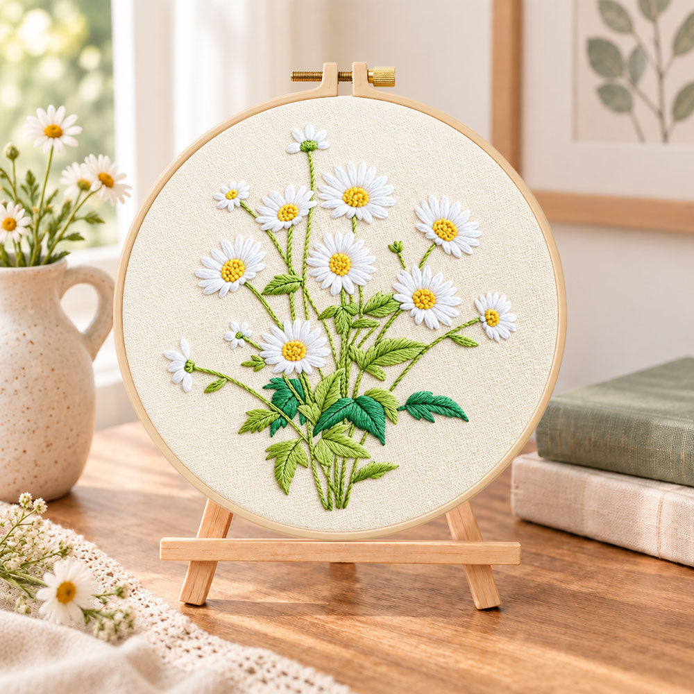 Daisies on beige background embroidery kit finished hoop displayed on a wooden stand as cosy tabletop decor