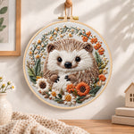 Daisy wreath hedgehog embroidery hoop wall art displayed as warm and cozy handmade home decor