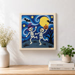 Finished dancing skeletons under moon artwork displayed on a wall