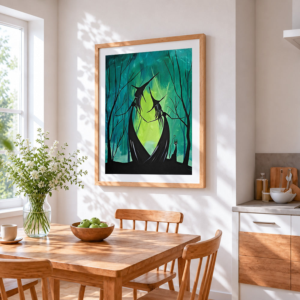 Dancing witches in a green forest cross stitch artwork displayed on wall as home decor