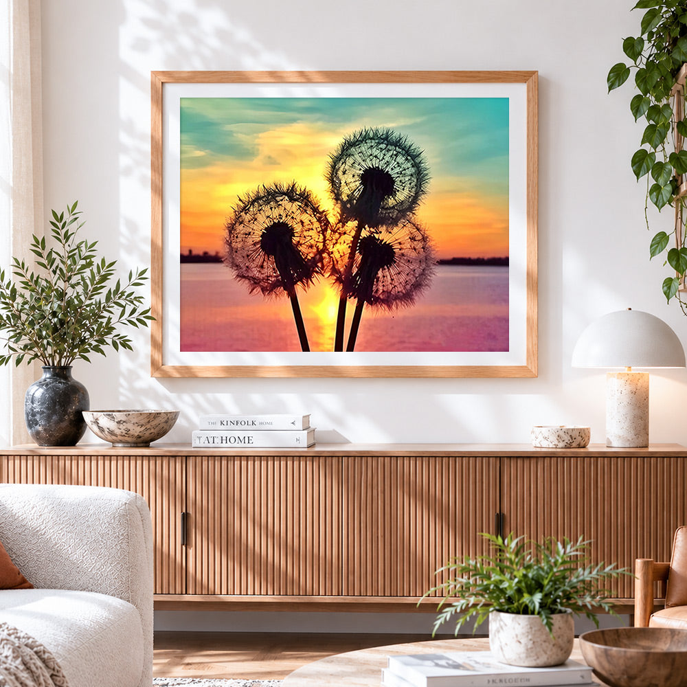 Finished dandelion silhouette at sunset cross stitch artwork displayed