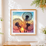 Finished dandelion silhouettes at sunset cross stitch artwork displayed
