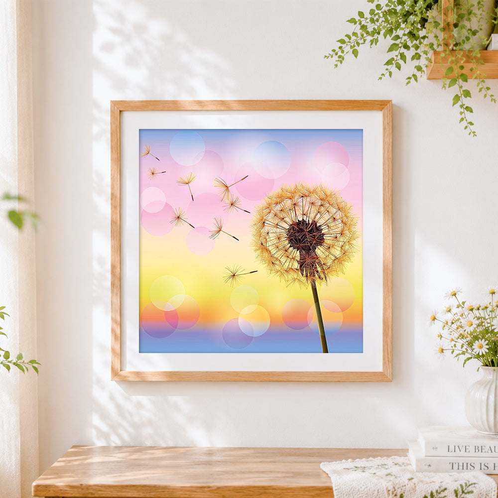 Finished dandelion with floating seeds cross stitch artwork displayed