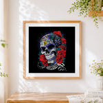 Finished dark style sugar skull cross stitch artwork displayed