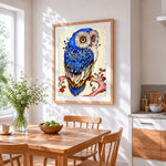 Decorative blue owl cross stitch artwork displayed on wall as home decor