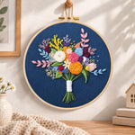 Deep blue mixed flower bouquet embroidery hoop wall art displayed as warm and cosy handmade home decor