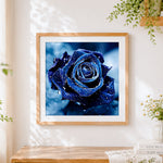 Finished deep blue rose with water droplets paint by numbers artwork displayed as home decor