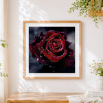 Finished deep red rose with water droplets paint by numbers artwork displayed as home decor