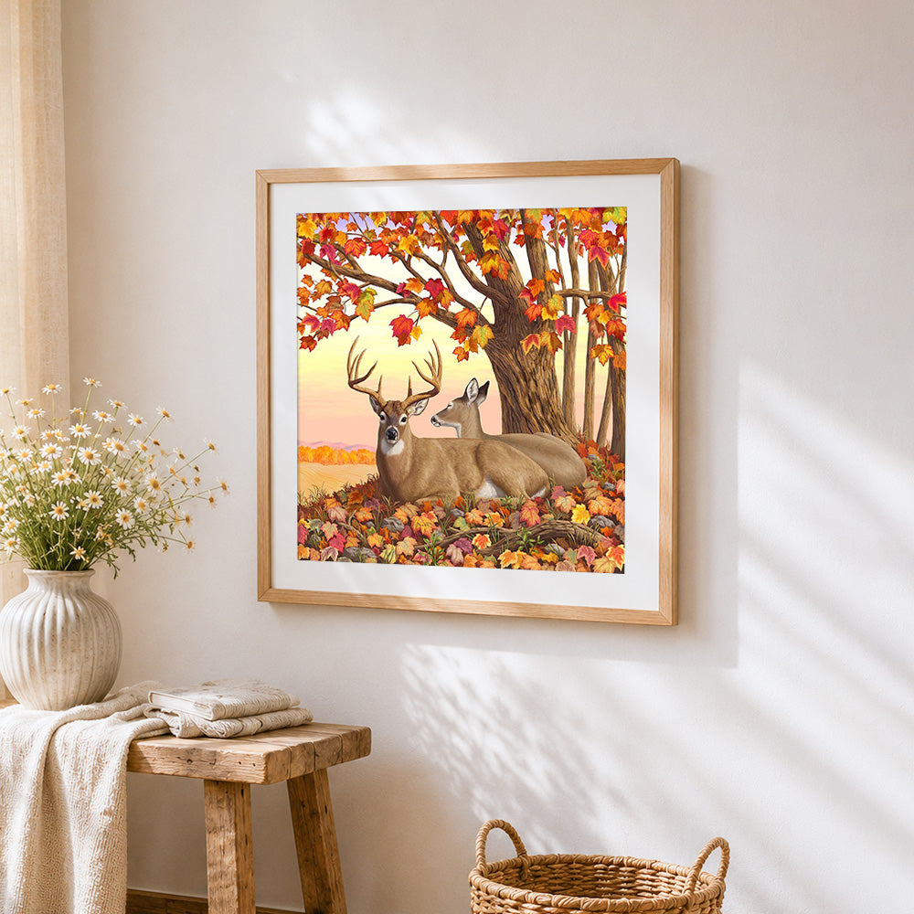 Deer family under autumn maple tree cross stitch artwork displayed on wall as home decor