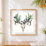 Finished deer skull with blue floral crown cross stitch artwork displayed