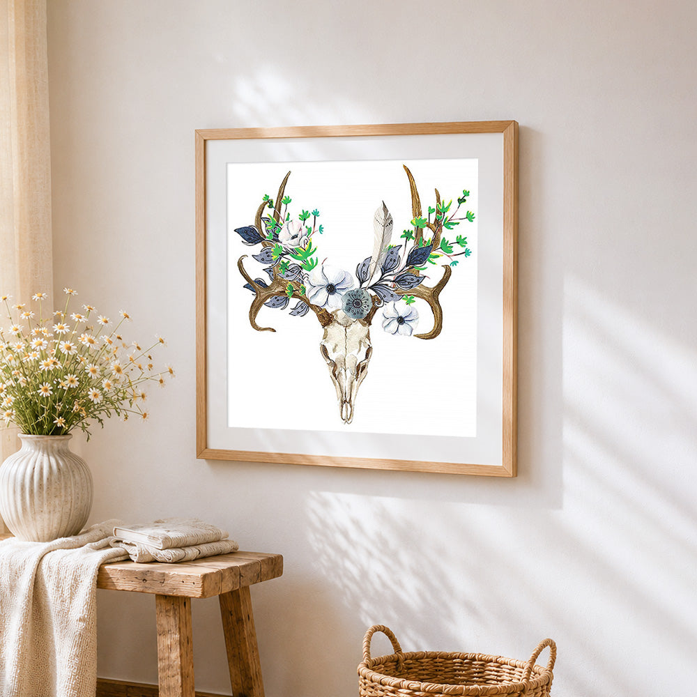 Deer skull with blue floral crown cross stitch artwork displayed on wall as home decor