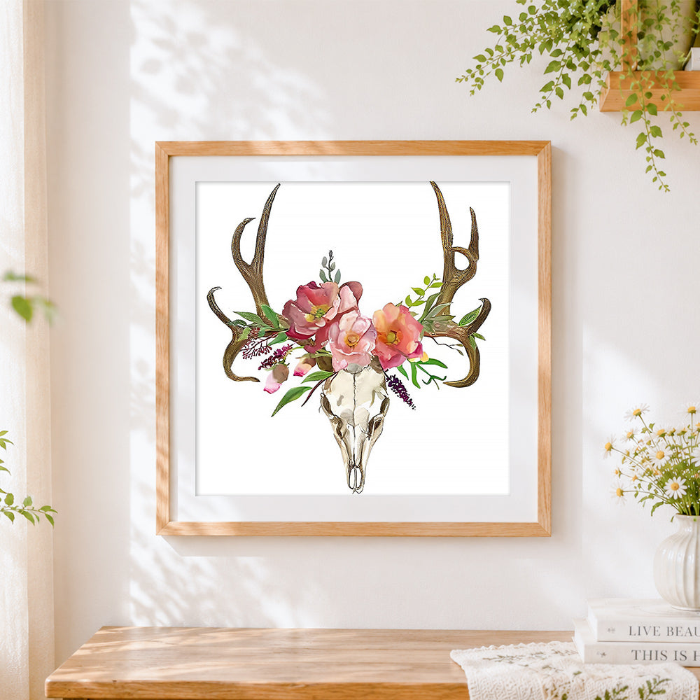 Finished deer skull with pink flowers cross stitch artwork displayed