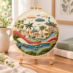 Desert stream hamlet embroidery kit finished hoop displayed on a wooden stand as cosy tabletop decor