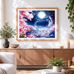 Finished dolphin couple and cherry blossom cross stitch artwork displayed