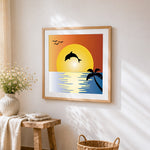 Dolphin silhouette at sunset cross stitch artwork displayed on wall as home decor