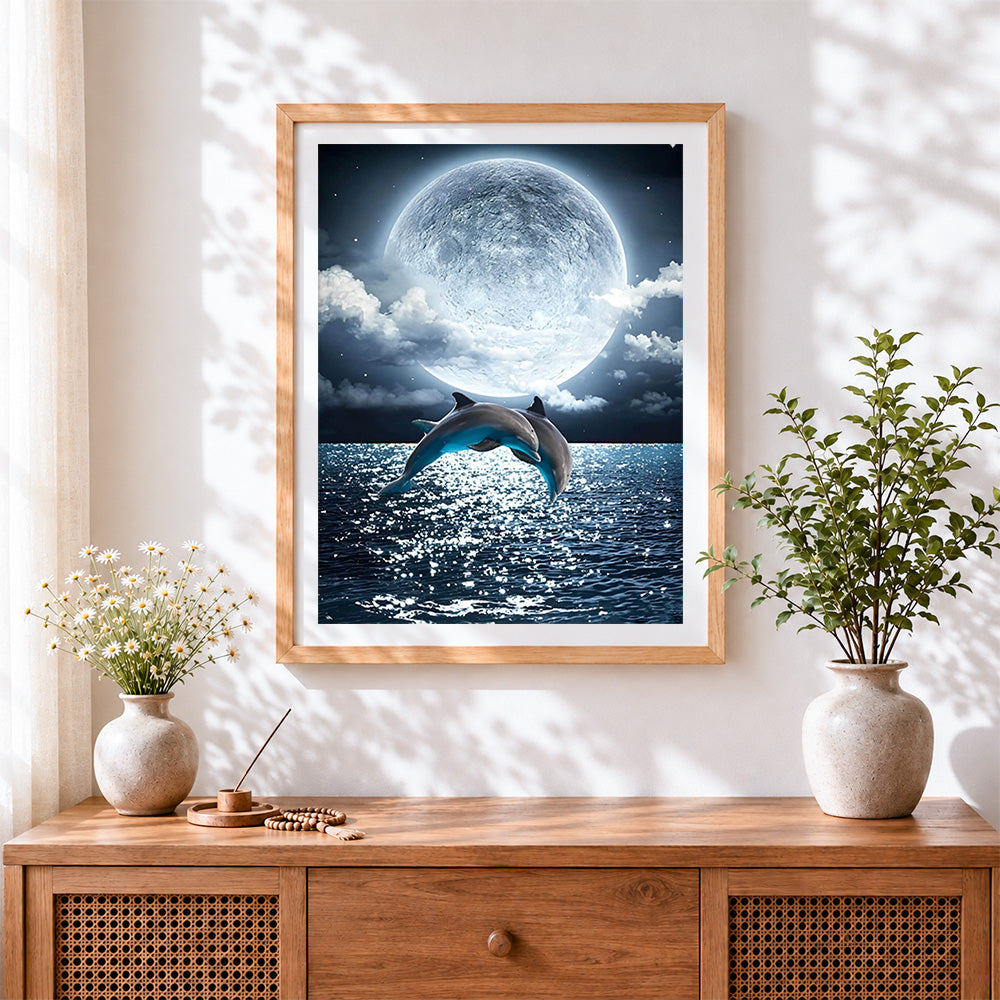 Finished dolphins jumping under a full moon cross stitch artwork displayed