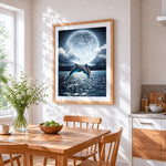 Dolphins jumping under a full moon cross stitch artwork displayed on wall as home decor