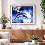 Finished dolphins jumping under full moon cross stitch artwork displayed