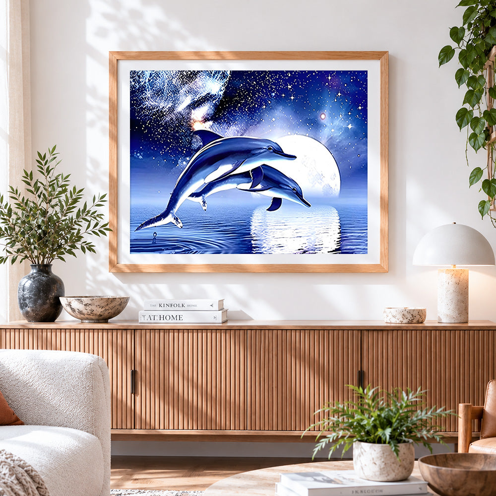 Finished dolphins jumping under full moon cross stitch artwork displayed