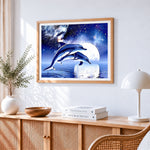 Dolphins jumping under full moon cross stitch artwork displayed on wall as home decor