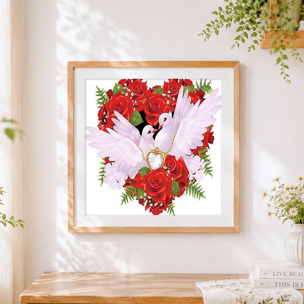 Finished doves and rose heart cross stitch artwork displayed