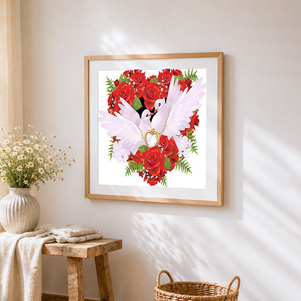 Doves and rose heart cross stitch artwork displayed on wall as home decor