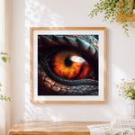 Finished dragon eye close-up cross stitch artwork displayed