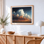 Dramatic clouds at sunset cross stitch artwork displayed on wall as home decor