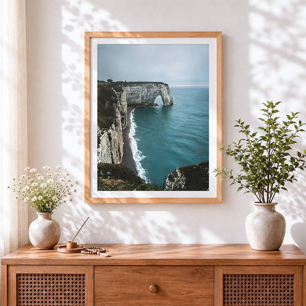 Finished dramatic coastal cliffs and sea arch cross stitch artwork displayed