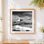 Finished dramatic lighthouse on a rocky coast cross stitch artwork displayed