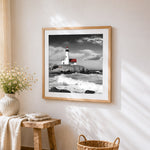 Dramatic lighthouse on a rocky coast cross stitch artwork displayed on wall as home decor