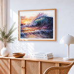Dramatic ocean wave at sunset cross stitch artwork displayed on wall as home decor