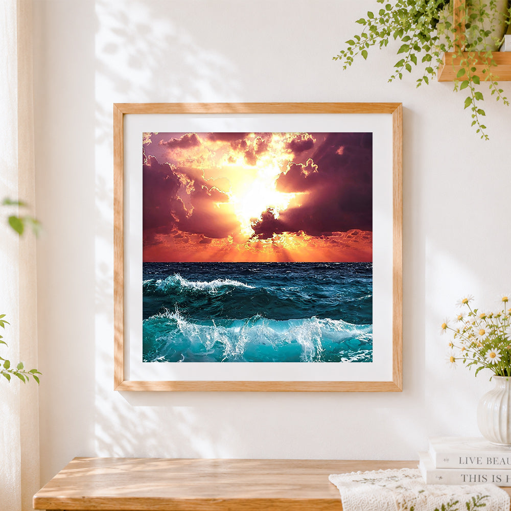 Finished dramatic ocean waves at sunset cross stitch artwork displayed