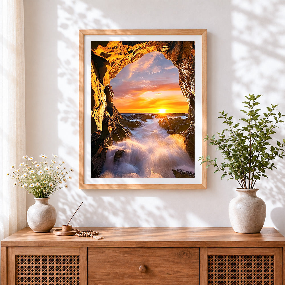 Finished dramatic sea cave sunset cross stitch artwork displayed