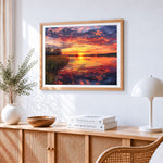 Dramatic sunset over wetlands cross stitch artwork displayed on wall as home decor