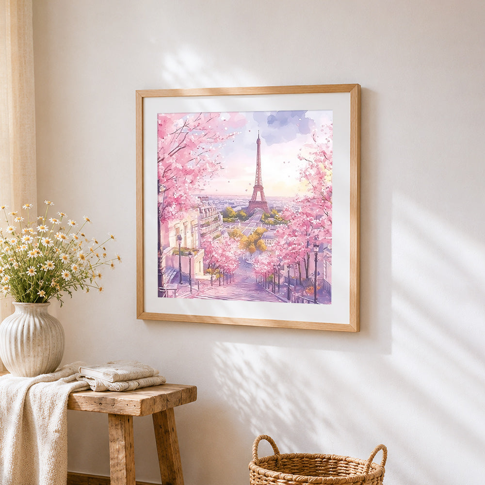 Dreamy pink eiffel tower cross stitch artwork displayed on wall as home decor