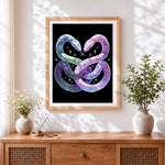 Finished dreamy twin snakes entwined cross stitch artwork displayed