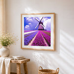 Dutch windmill and tulip fields cross stitch artwork displayed on wall as home decor