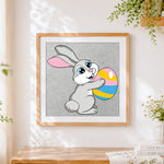 Finished easter bunny with colourful egg cross stitch artwork displayed