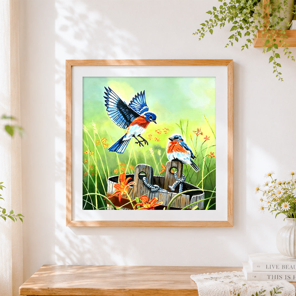 Finished eastern bluebirds and wooden bucket cross stitch artwork displayed