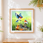 Finished eastern bluebirds and wooden bucket cross stitch artwork displayed